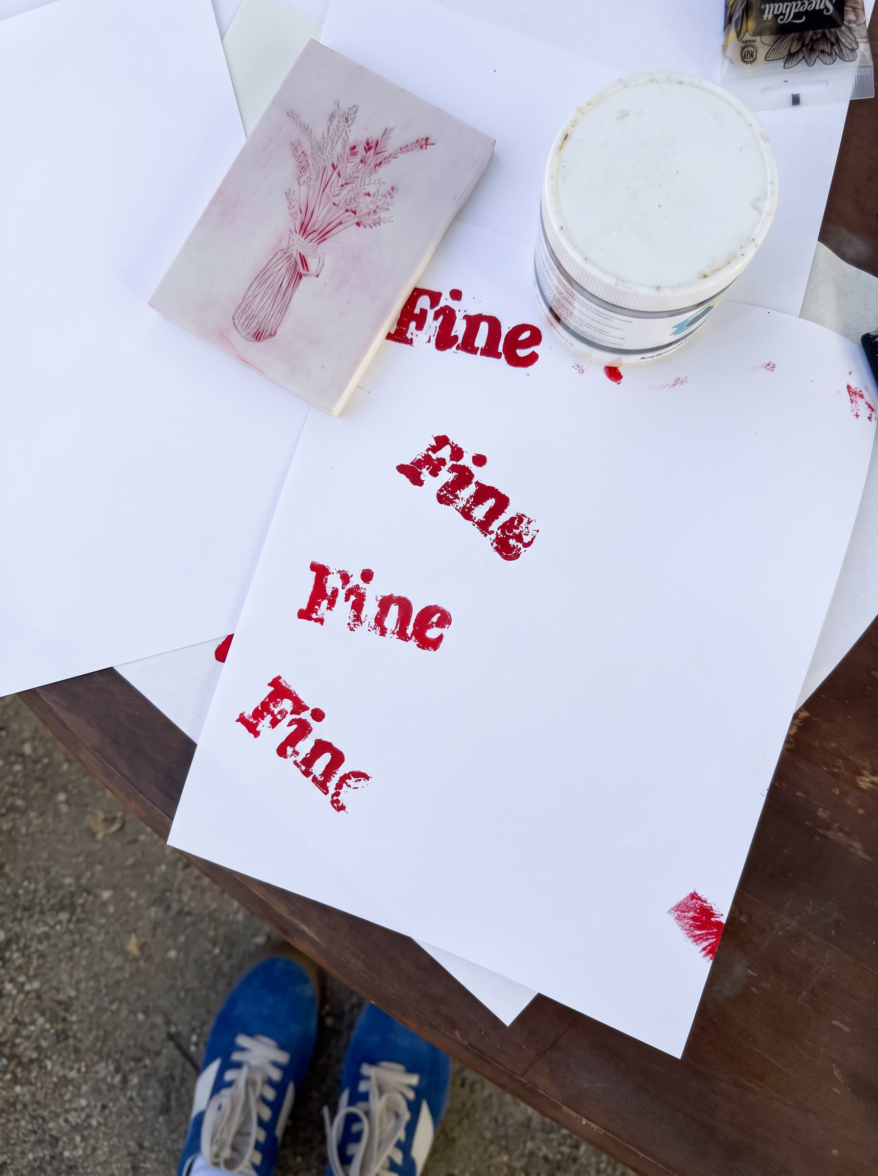 Hand-printed red block prints reading Fine drying in the afternoon light